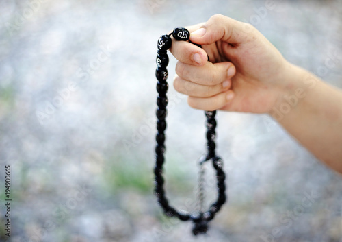 Muslim Woman hand with rosary