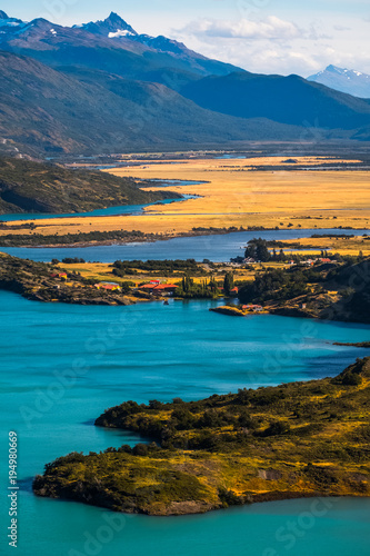 Valley with yellow fields, mountains, blue lakes and rivers. Torres del Paine National Park, Chile