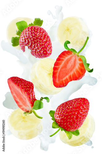 Flying strawberries and banana slices with a spray of milk