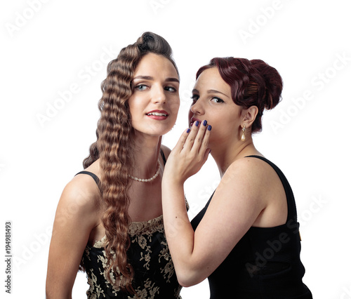 Two young women whispering gossip on white background.