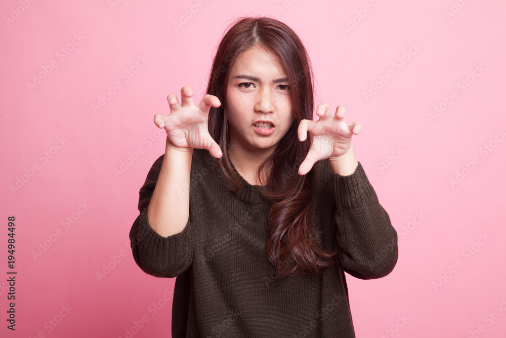 Young Asian woman with spooky hands gesture. Young Asian woman with spooky hands gesture.
