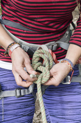 Fototapeta climber making a knot