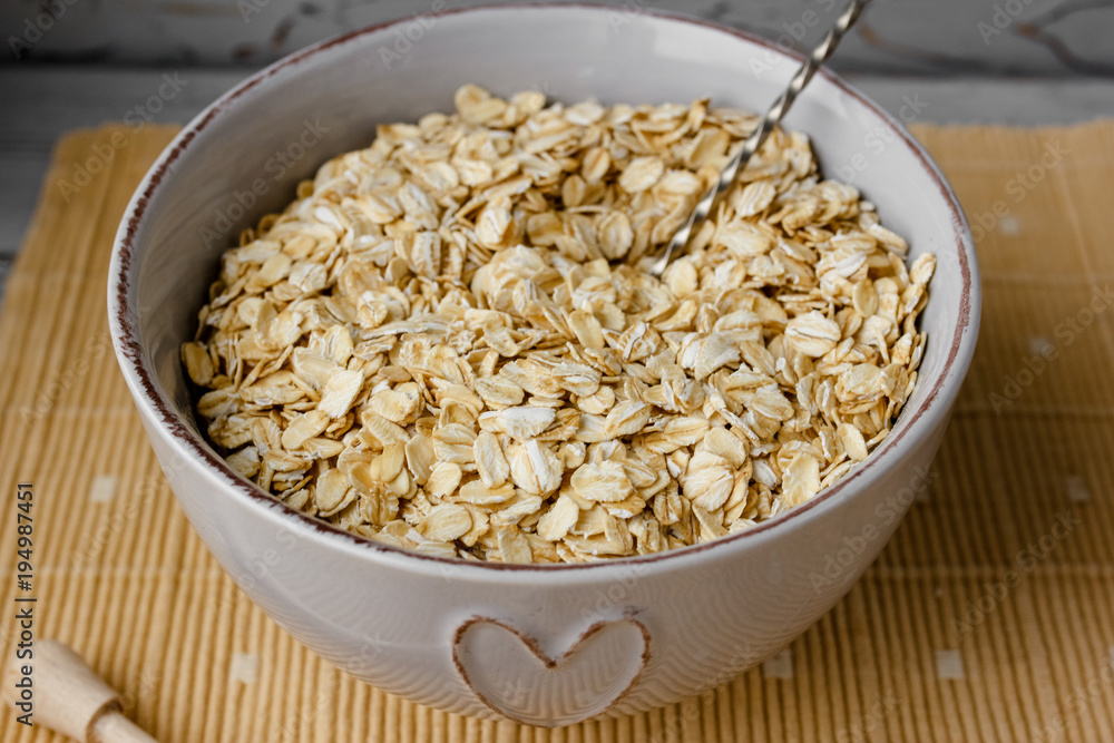 Healthy breakfast: oatmeal cereal, cup of milk, jar of homemade jam, oatmeal cookies. Flowers in a vase on a background. Coconut biscuits on a saucer. Exquisite romantic breakfast. Food blog ideas Healthy breakfast: oatmeal cereal, cup of milk, jar of homemade jam, oatmeal cookies. Flowers in a vase on a background. Coconut biscuits on a saucer. Exquisite romantic breakfast. Food blog ideas