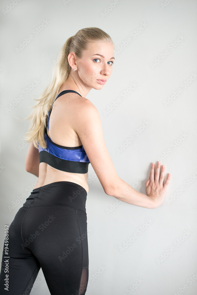 Young woman wearing sport clothes and looking back