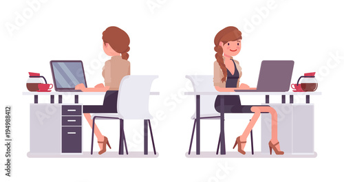 Pretty female office employee sitting at desk