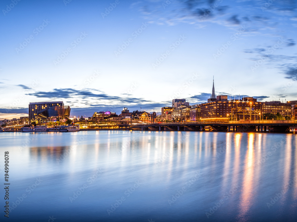 Stockholm sunset skyline with City Hall as seen from Riddarholmen.
