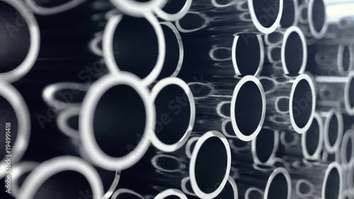 Metal pipes stacked. Heap of shiny metal steel pipes with selective focus effect. 3D animation 4k