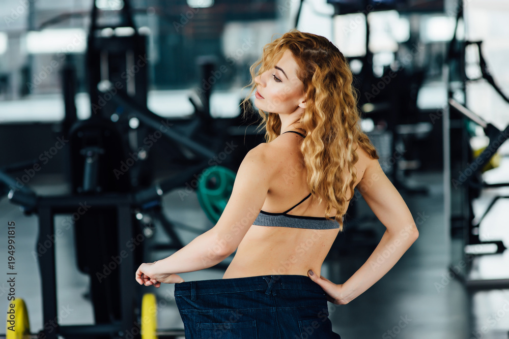 Woman with red hair shows her weight loss. Woman with red hair shows her weight loss.