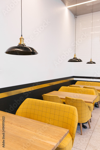 Tables and yellow chairs in cafe photo