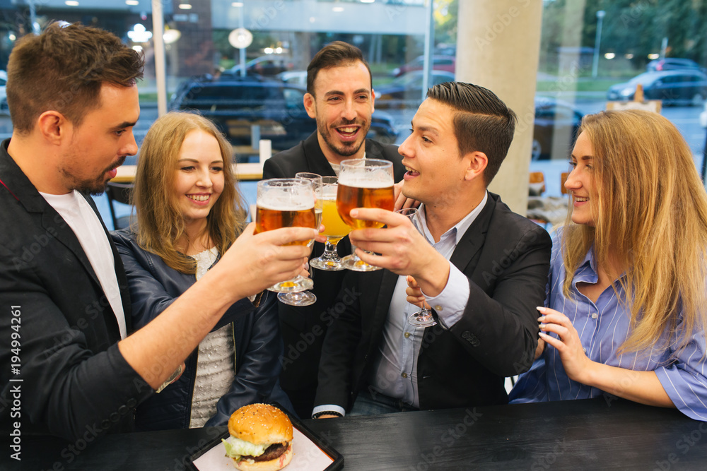 Friends clinking glasses in pub Friends clinking glasses in pub
