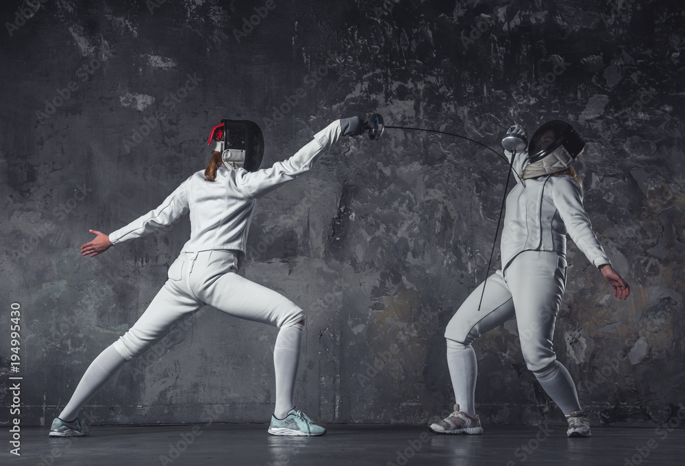 Two women fencing