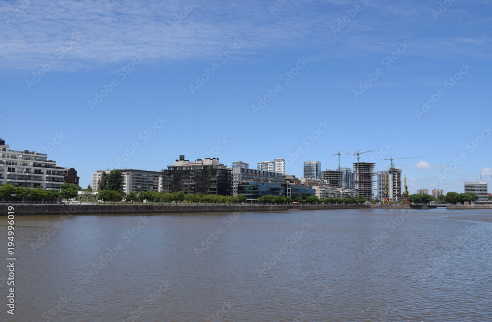 a city is being built, a new district with skyscrapers near the river, near the embankment