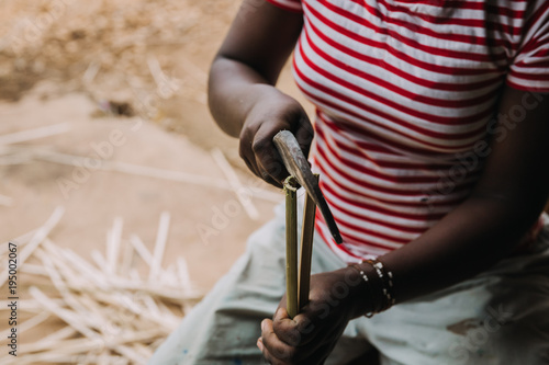 person working with bamboo in Rwanda, Africa