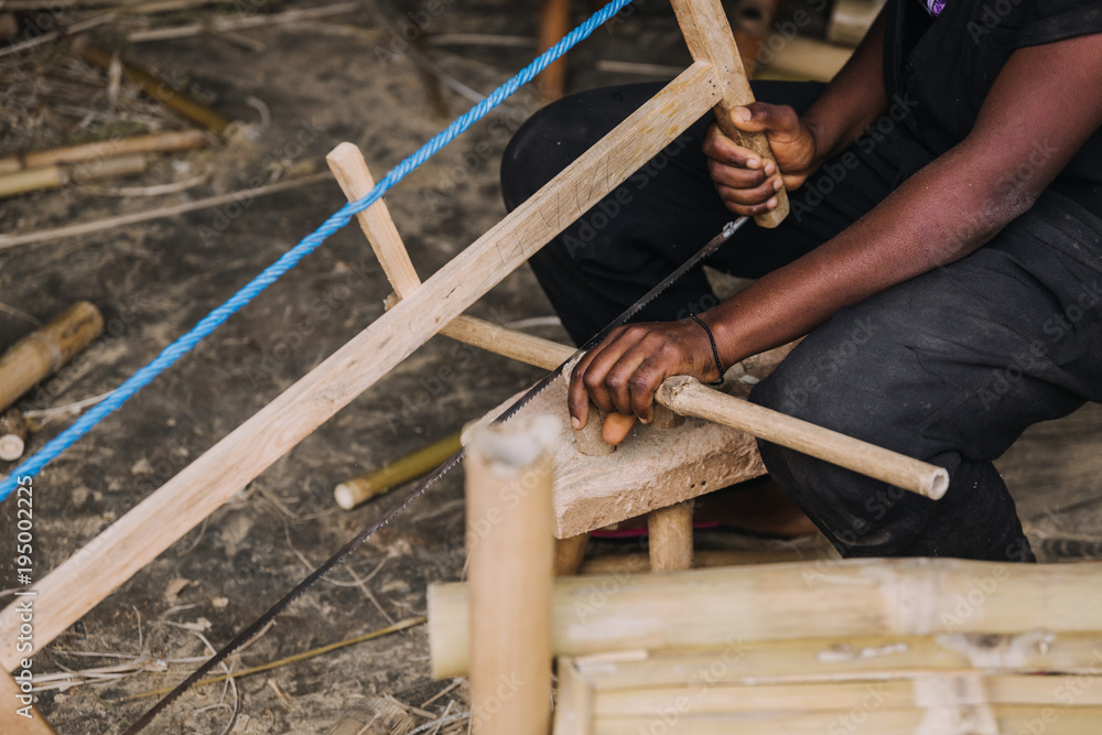 person working with bamboo in Rwanda, Africa