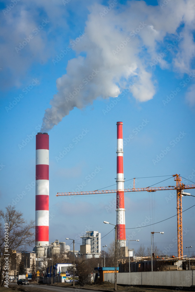 The power station with two smoke stacks and crane