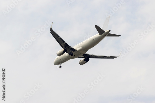 Closeup a passenger aircraft is flying in the sky.