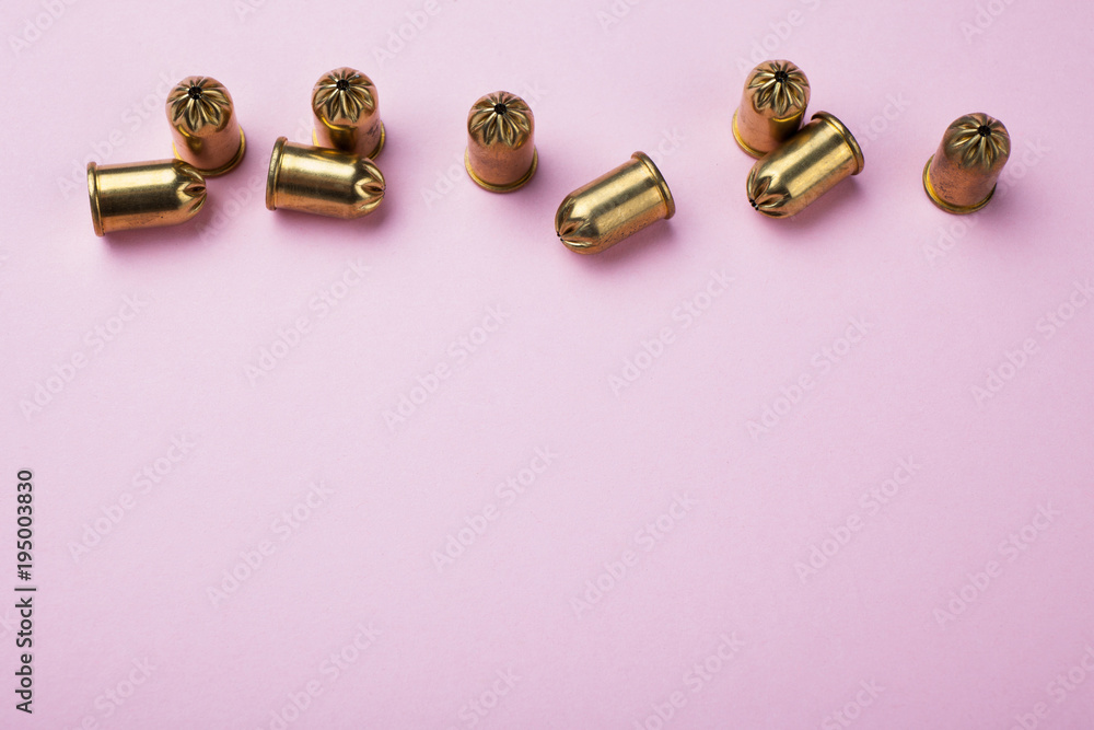 Training bullets on a pink background, top view. Copy space. Training bullets on a pink background, top view. Copy space.