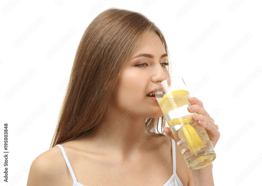Beautiful young woman drinking fresh lemonade on white background Beautiful young woman drinking fresh lemonade on white background