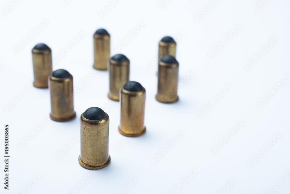 Old rubber bullets on a white background, selective focus. Old rubber bullets on a white background, selective focus.