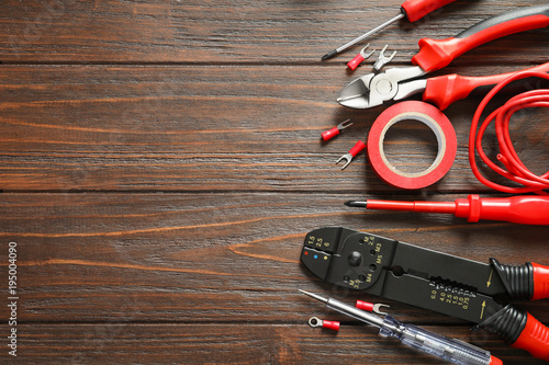 Different electrical tools on wooden background