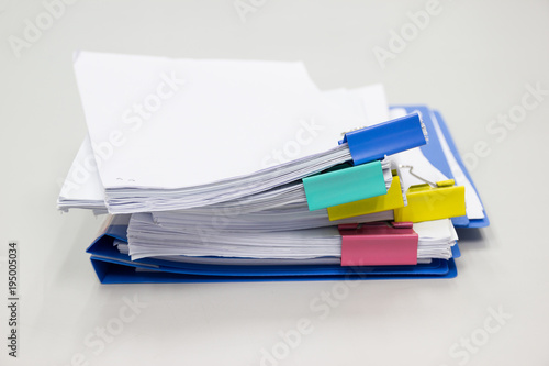 Stack of papers documents in archives files with paper clips on desk at offices, business concept.