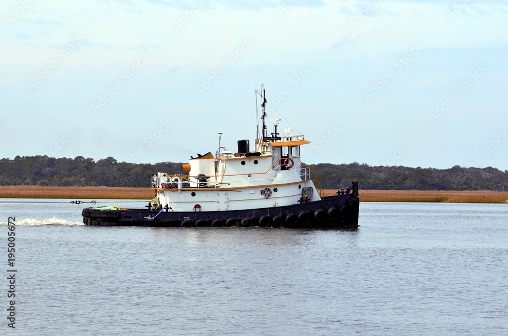 Tugboat cruising on the river background