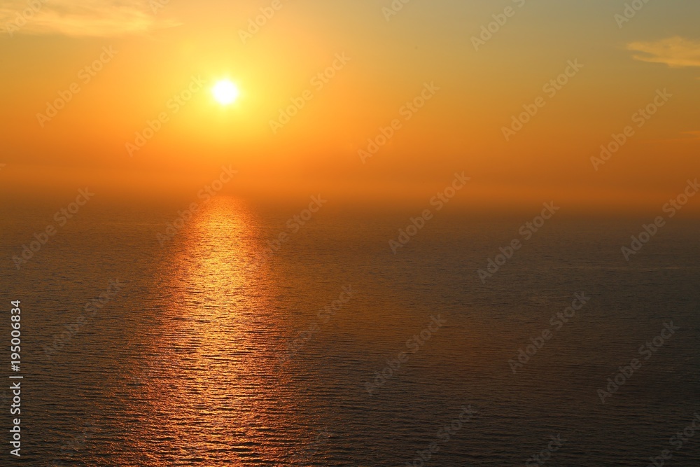the sunset in the haze at sea. pamorama. gorizont