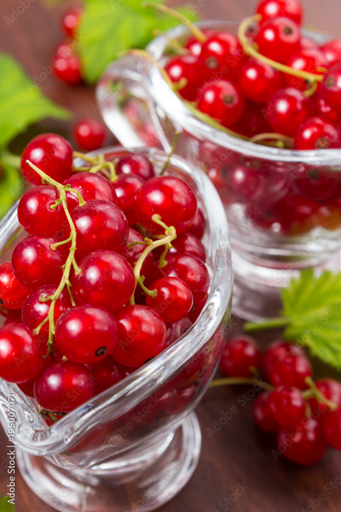 Red currant fruits on a wooden background Red currant fruits on a wooden background