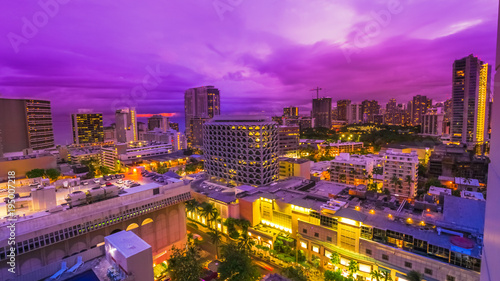Violet twilight of cityscape of Waikiki in Oahu island, Hawaii, United States. City night lights and nightlife concept.