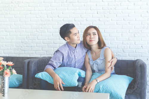 Women lovers are sitting close together at sofa of cafe with the loevly moment. photo