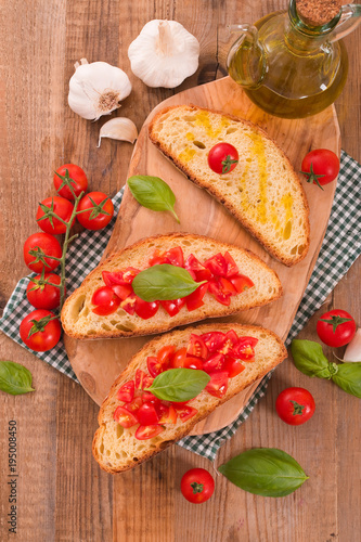Bruschetta bread with basil and chopped tomatoes. 