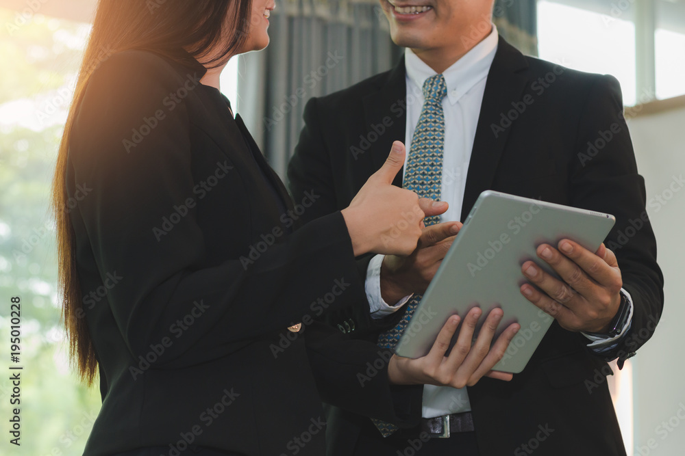 Business people talking and smiling content on tablet together, business concept Business people talking and smiling content on tablet together, business concept