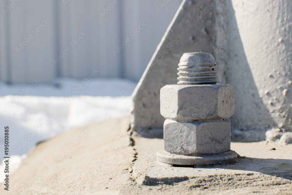bolt with two wound nuts, painted gray, sticking out of the floor bolt with two wound nuts, painted gray, sticking out of the floor