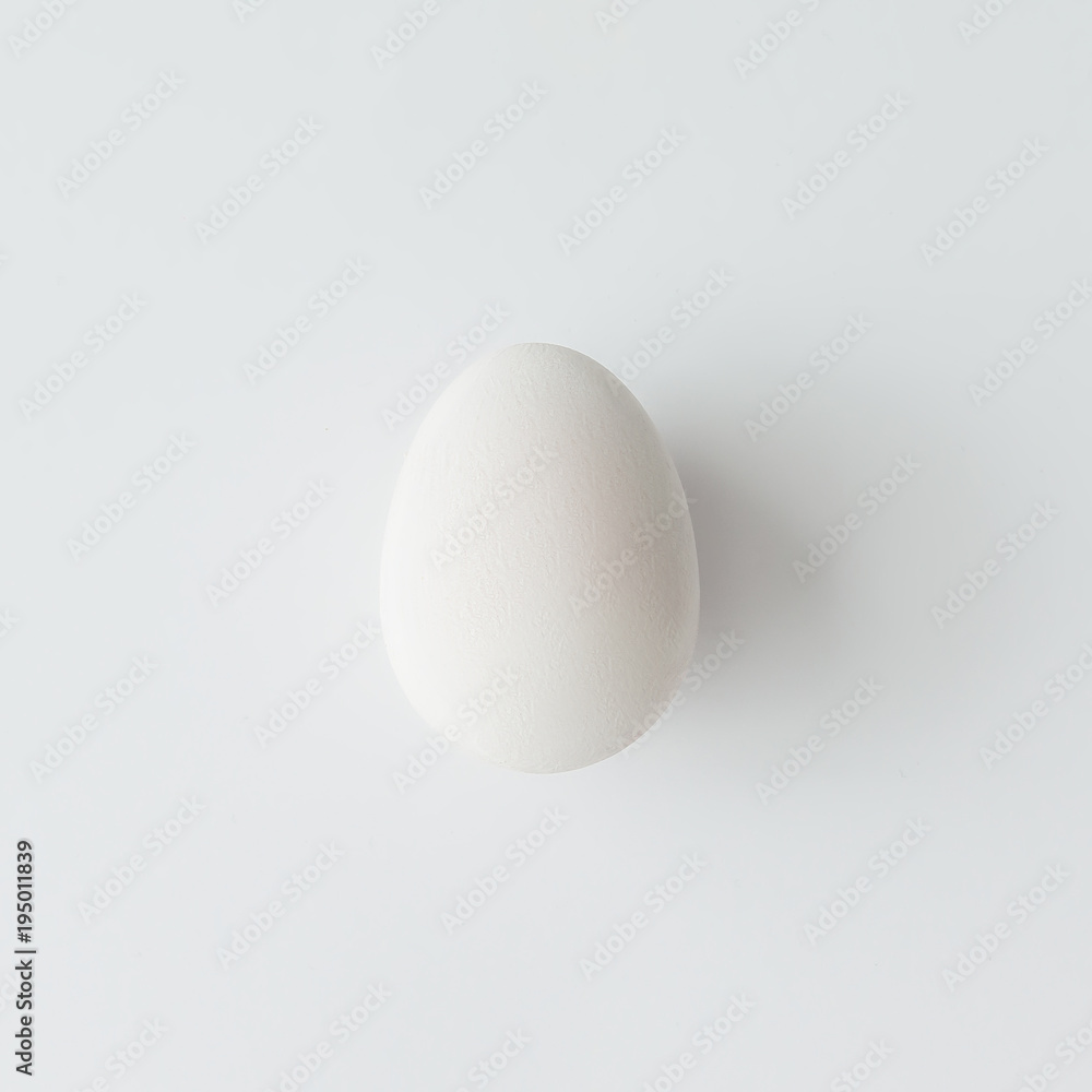 Minimal white Easter egg on bright background. Flat lay. Minimal white Easter egg on bright background. Flat lay.