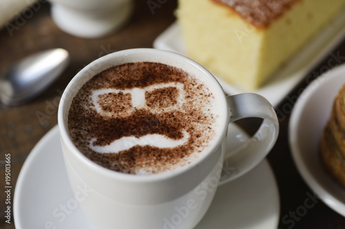 man face in a cup of cappuccino