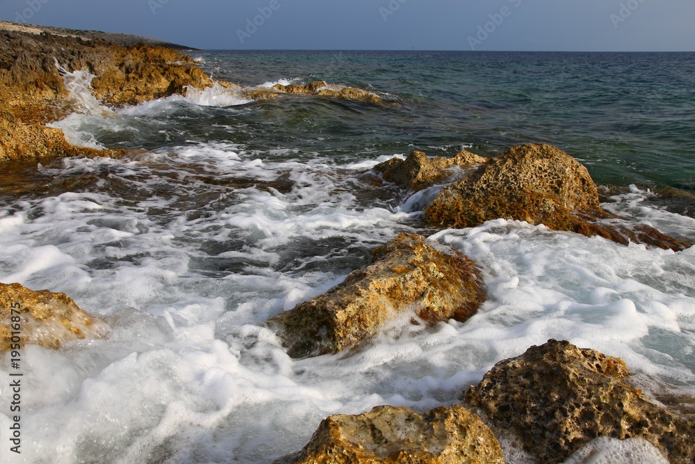 coastal stones at sea foam from the waves