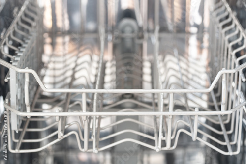 empty basket in a dishwasher, copy space in the blurry background