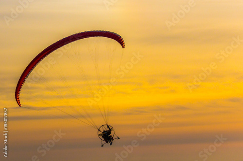 A paraglider flying at sunset. Vacation holidays background wallpaper