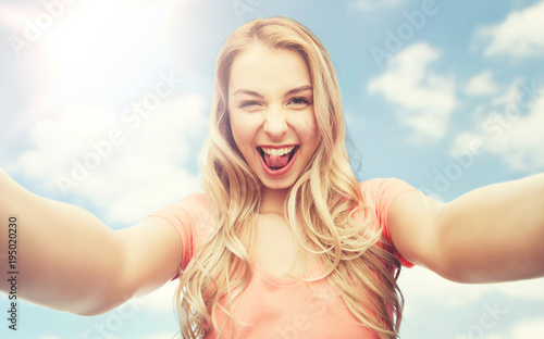 happy smiling young woman taking selfie