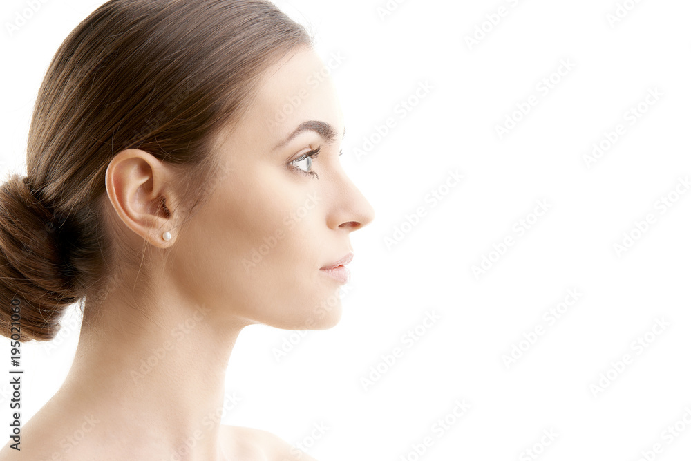 Woman face profile shot. Beautiful young woman with perfect skin looking away while standing at isolated white background. Woman face profile shot. Beautiful young woman with perfect skin looking away while standing at isolated white background.