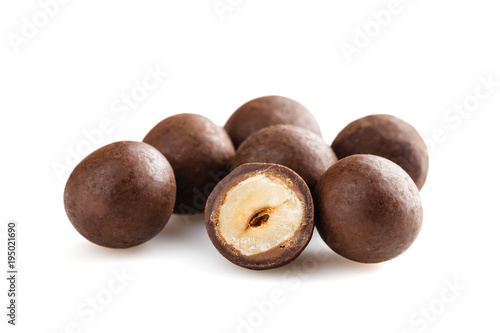 Heap of sugared hazelnuts dragees in chocolate isolated on white background