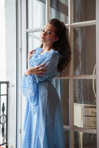 Free Download Beautiful bride young woman in a blue long peignoir in a wedding morning - GFXLoad