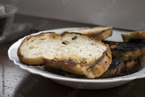 Burnt white bread on a plate.