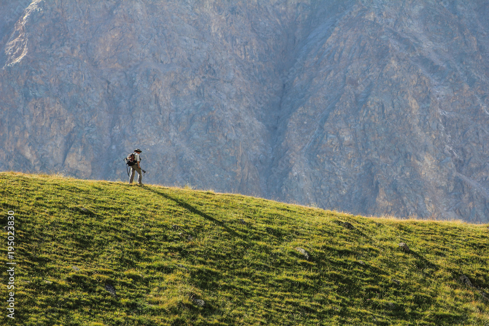 Small man in a mountain scenery