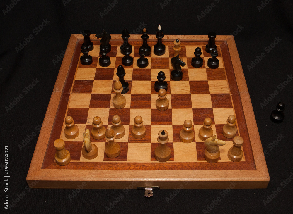 Abstract composition of chess figures. Isolated on black background,children's mat Abstract composition of chess figures. Isolated on black background,children's mat