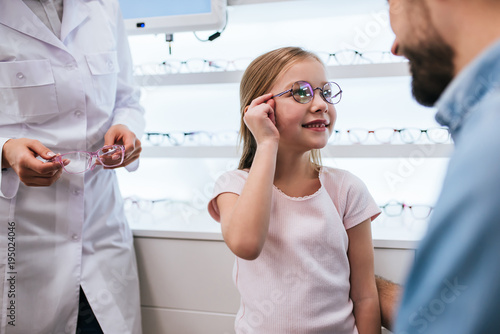 Dad with daughter in ophthalmology clinic