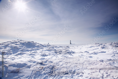 Standing on the ice of Lake Michigan in Frankfort, Michigan with the lighthouse in background