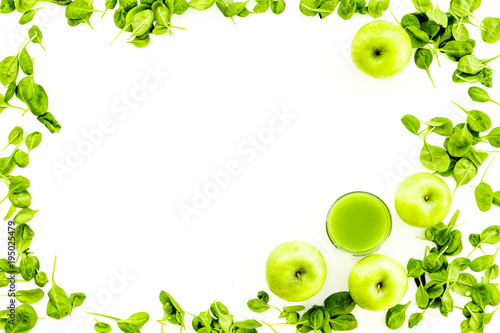 Green vegetables background with vegetable smoothies. Fresh apples, arugula salad on white background top view copy space