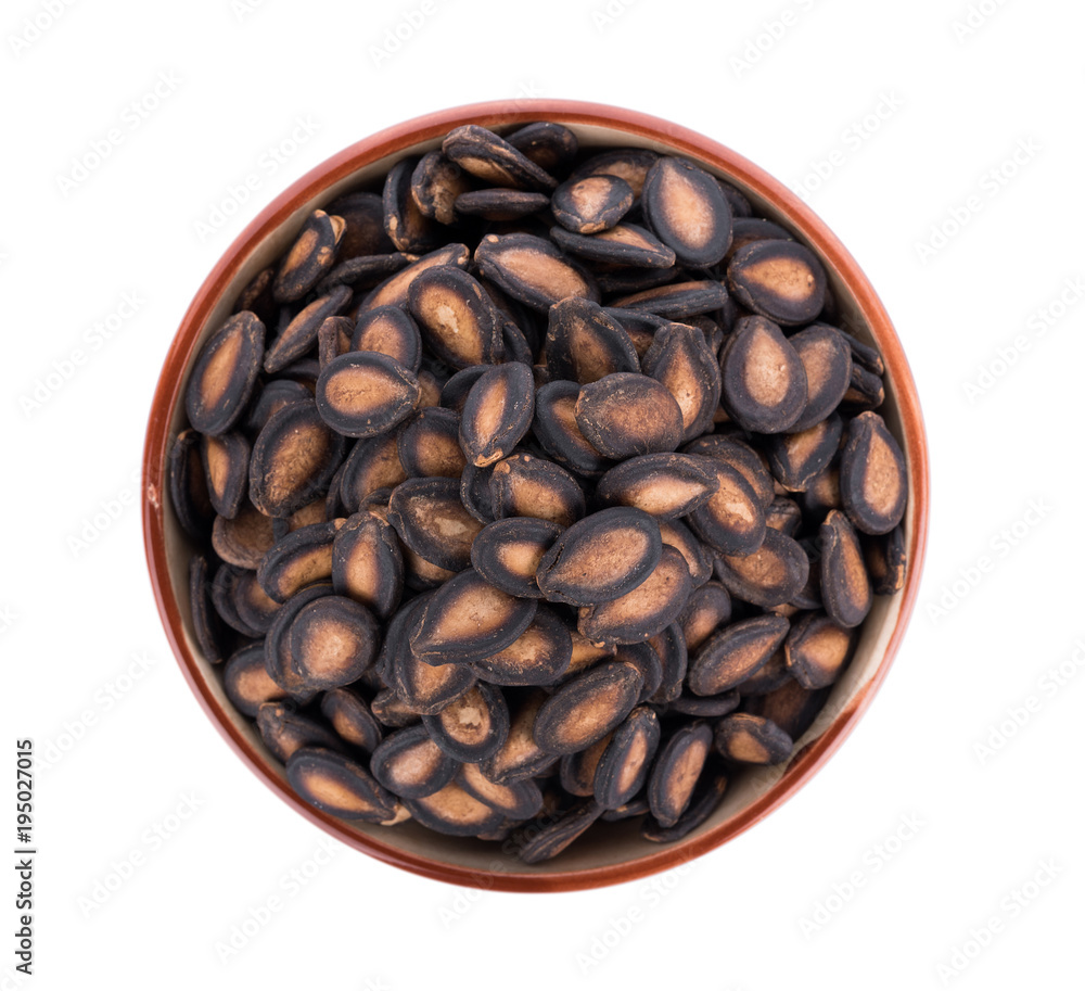 watermelon seeds in bowl isolated on white background watermelon seeds in bowl isolated on white background