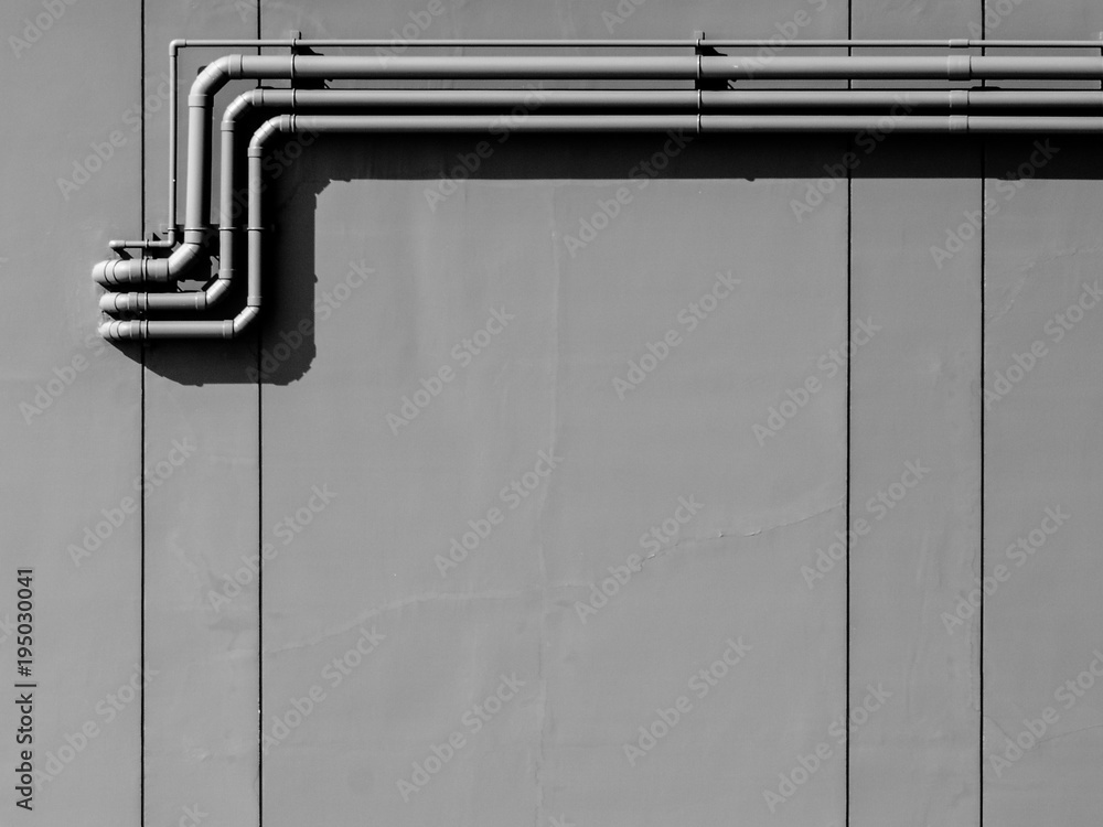 plastic water piping system installed at the concrete wall Stock Photo